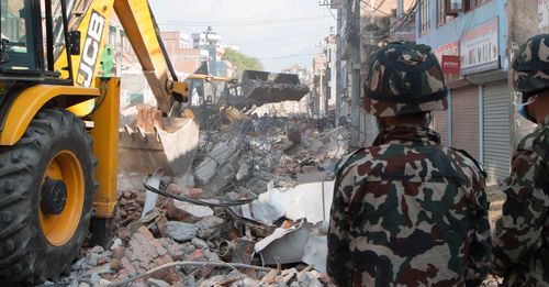 Earthmovers clear debris from the site of a building that collapsed in an earthquake in Kathmandu, Nepal, Tuesday, May 12, 2015. A major earthquake has hit Nepal near the Chinese border between the capital of Kathmandu and Mount Everest less than three weeks after the country was devastated by a quake. (AP Photo/Ranup Shrestha) ... Nepal Earthquake ... 12-05-2015 ... Kathmandu ... Nepal ... Photo credit should read: Ranup Shrestha/Unique Reference No. 22983026 ...
