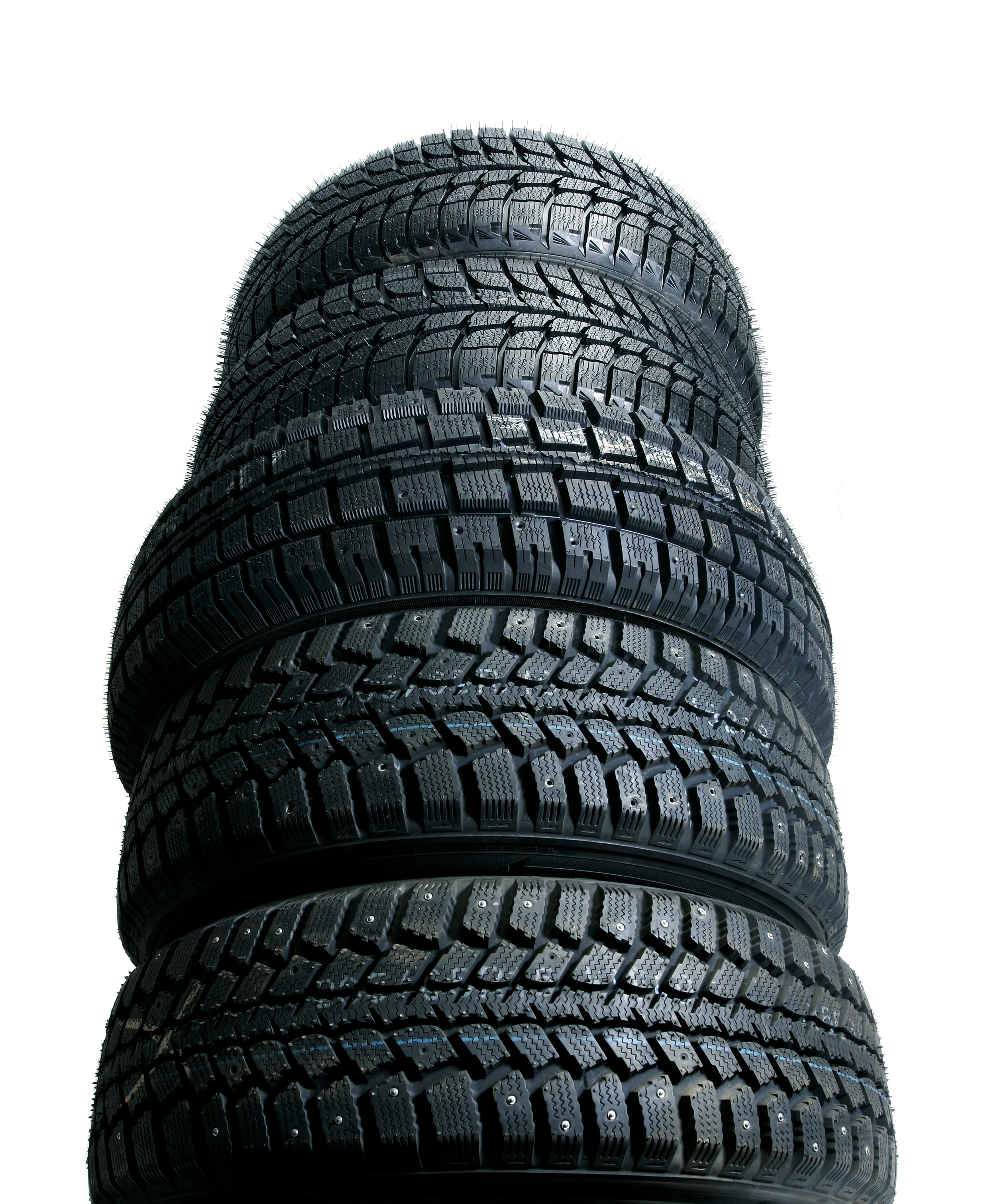 Brand new tires stacked up and isolated on white background - worms view